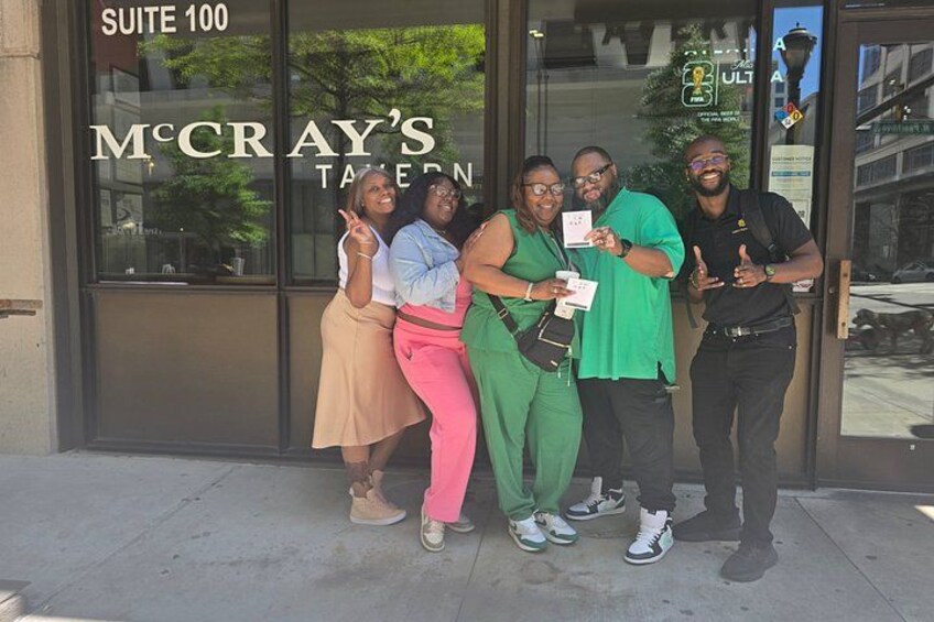 A group of people posing in front of McCray's Tavern. 2