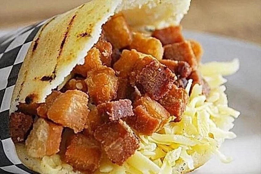 A sandwich with crispy bacon and shredded cheese. 4