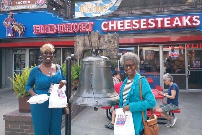 Chit Chat Atlanta Tourists in front of the liberty bell at Big Dave's Cheesesteaks 4