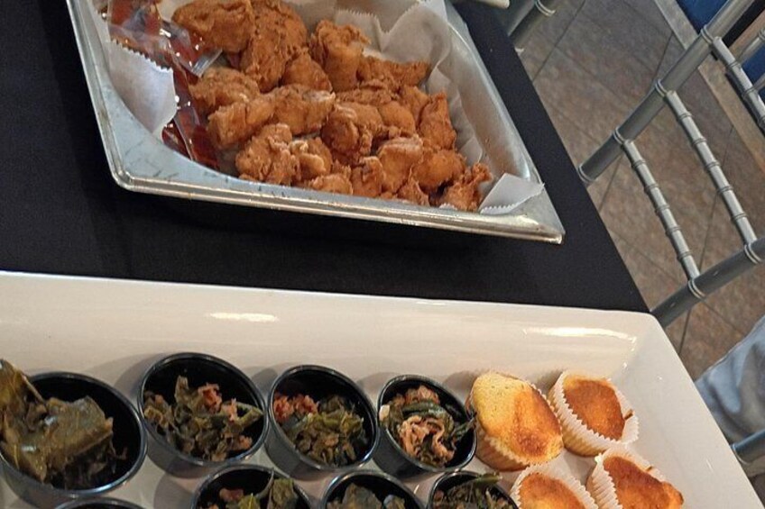 A tray of fried chicken and a variety of side dishes on a table. 2