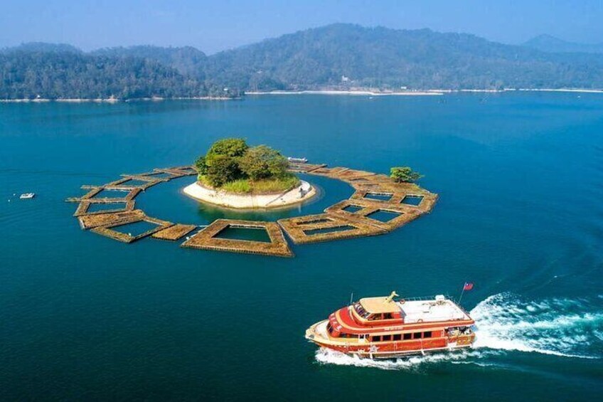 A circular island with a boat in the foreground. 1