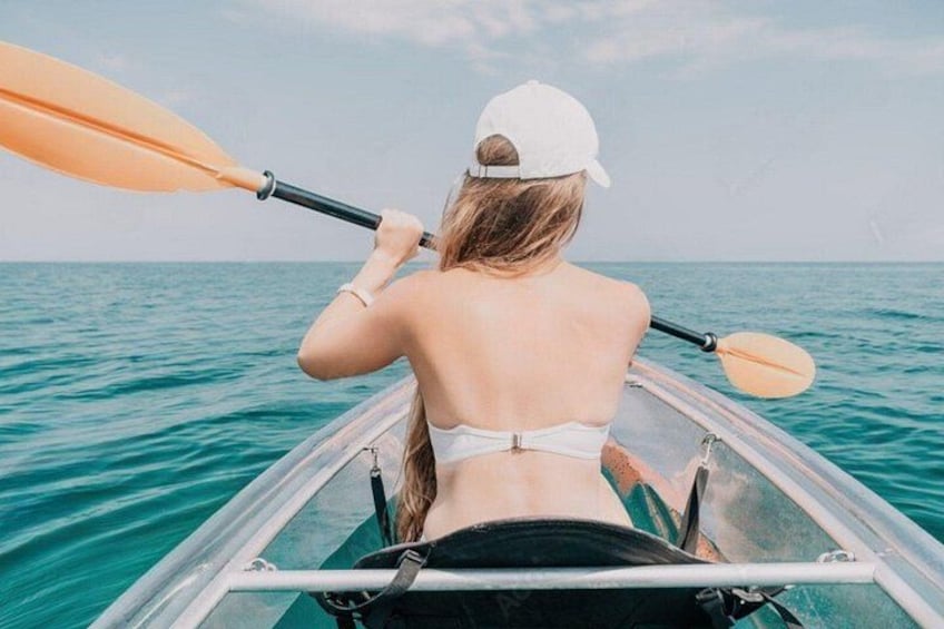 A person kayaking on a calm sea. 4