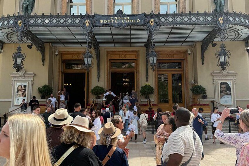 A crowded entrance to a building with ornate ironwork and a sign reading 'CASA MONTEROLO'. 3