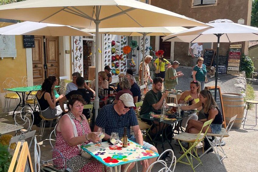 People dining outdoors at a restaurant with tables and umbrellas. 2