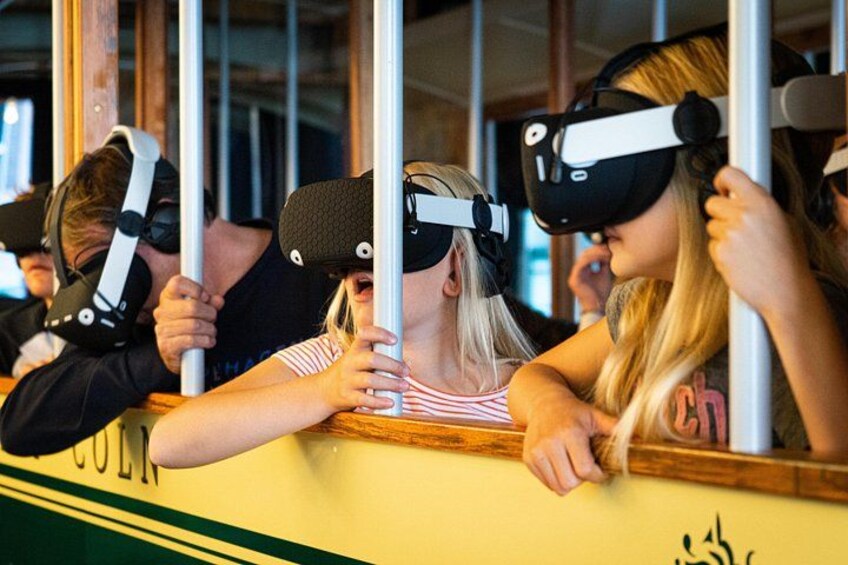 People wearing VR headsets on a yellow bus. 4
