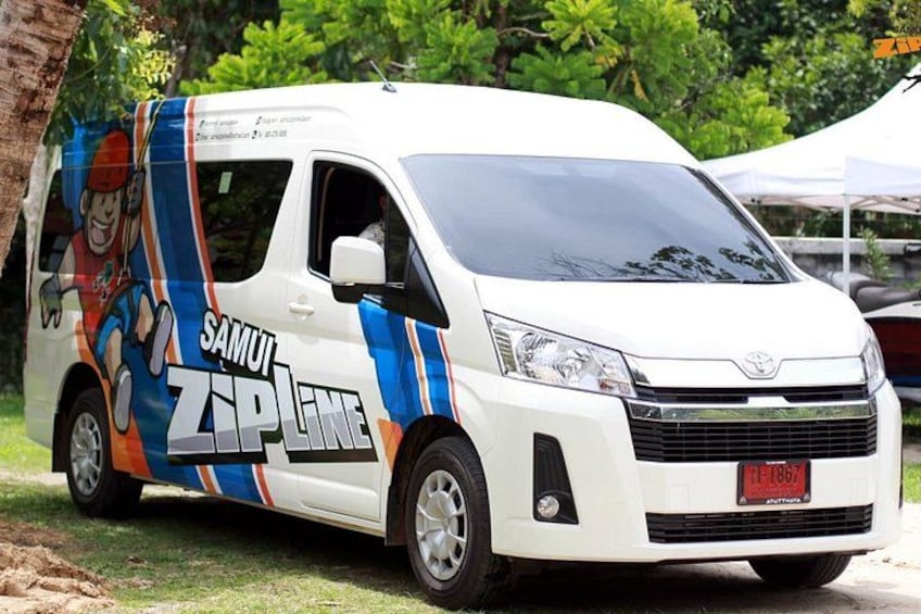 A white van with colorful graphics and text on its side, parked outdoors. 5