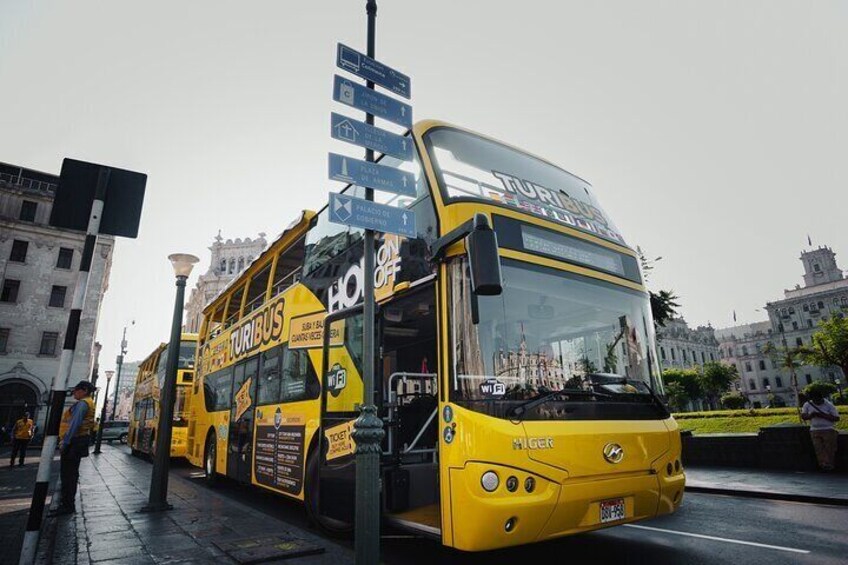 A yellow double-decker bus with "TURIBUS" and "HOT OFF" on the front. 5