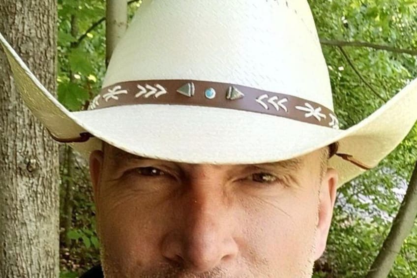 A person wearing a cowboy hat with a decorative band. 2