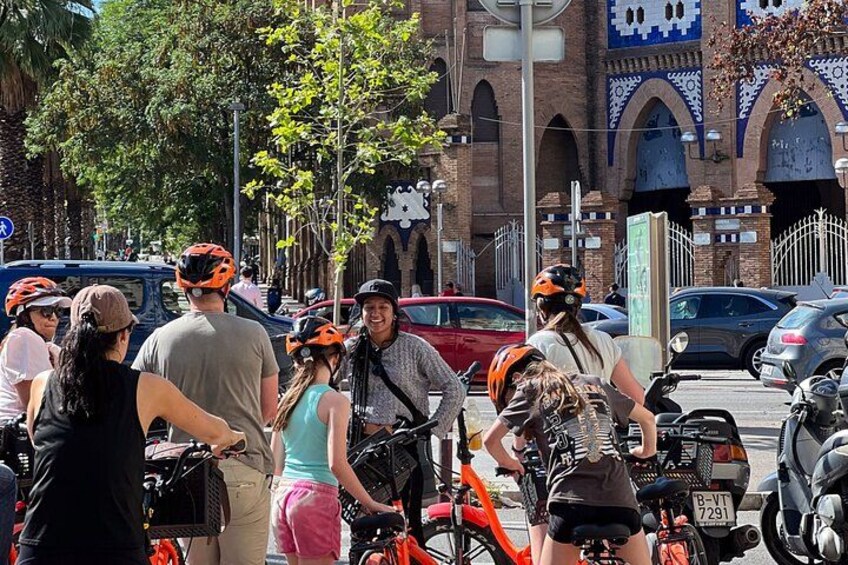 A group of people with bicycles and helmets on a street. 2