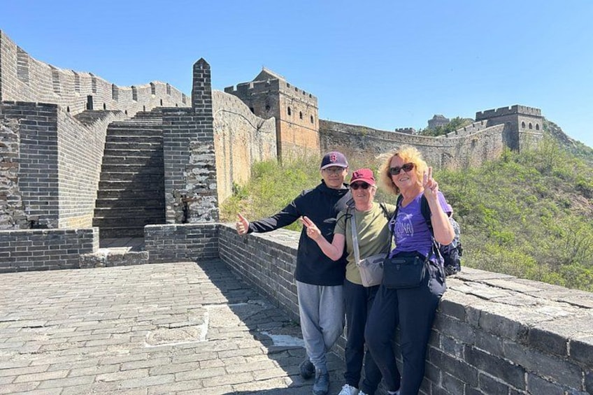 A group of people standing on the Great Wall of China. 1