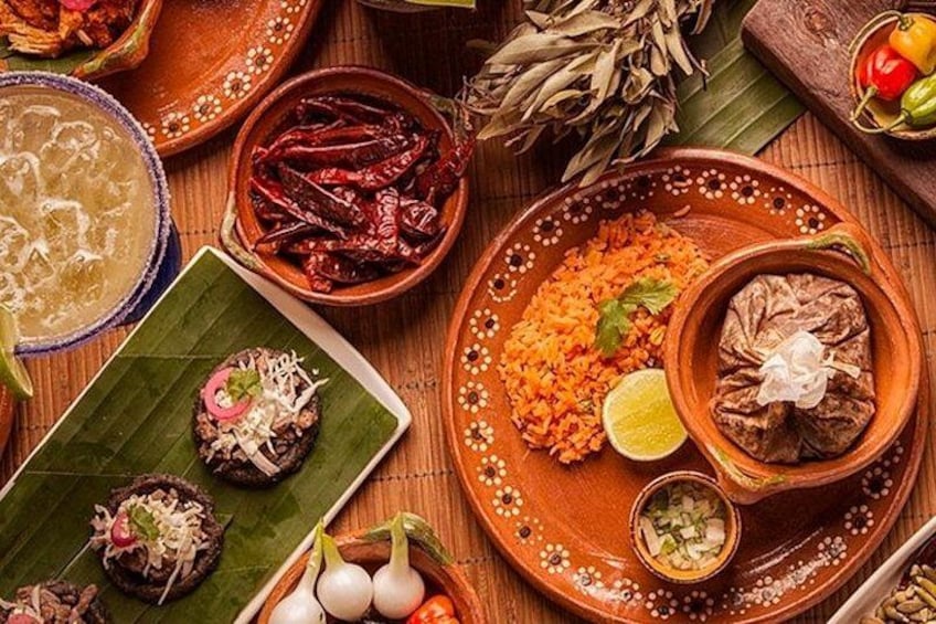 A variety of traditional Mexican dishes, including tacos, rice, and a mole sauce. 4