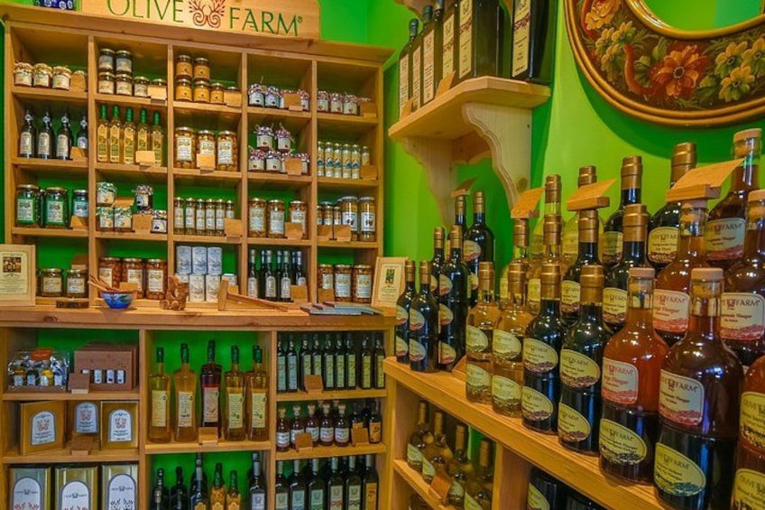 A store with shelves of olive oil and other products. 3