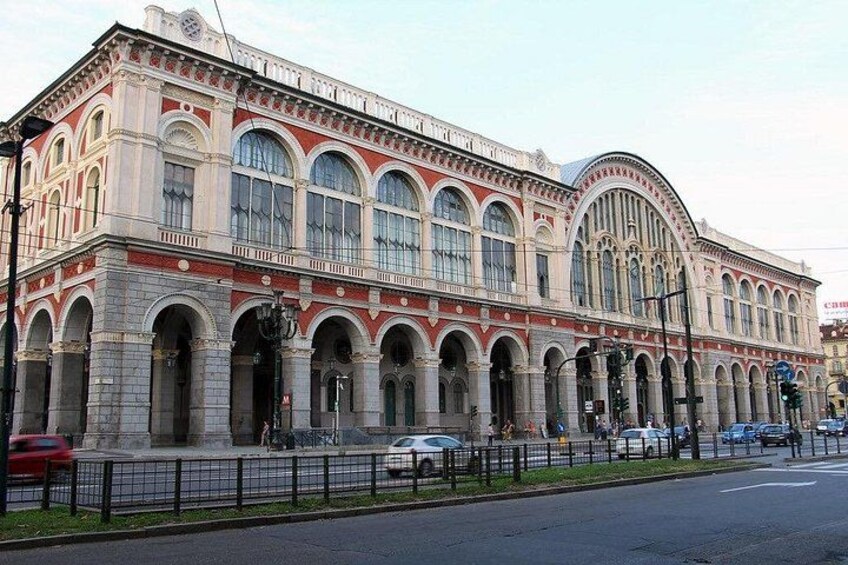 A large, ornate building with arched windows and a curved facade. 5