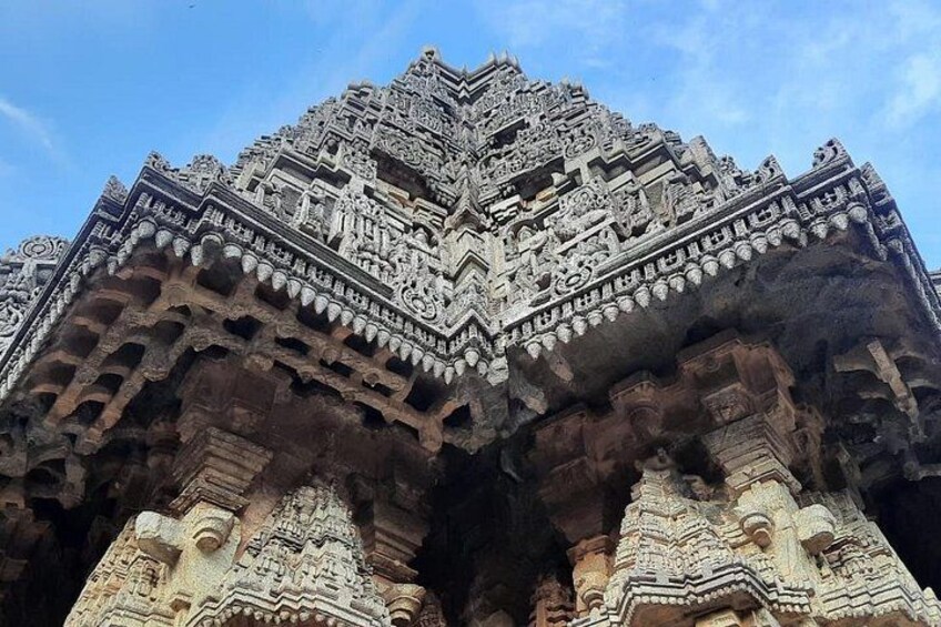 A detailed stone temple with intricate carvings and a tiered roof structure. 4