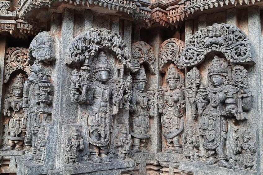 Detailed stone carvings of deities on a temple wall. 5