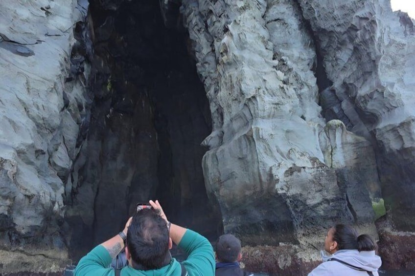 Un grupo de personas observando la entrada de una cueva. 3