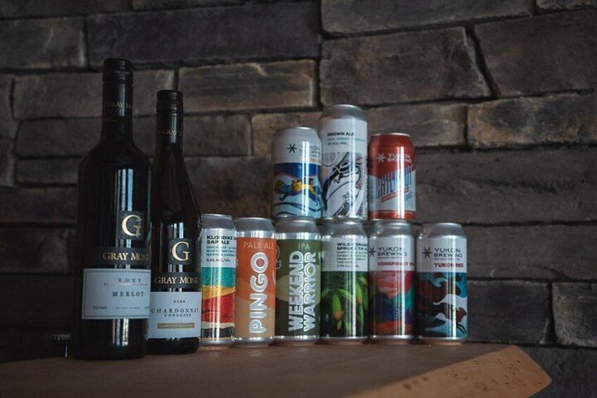 A bottle of Gray Monk Merlot and a bottle of Chardonnay, along with several cans of beer and a bottle of Pale Ale. 2