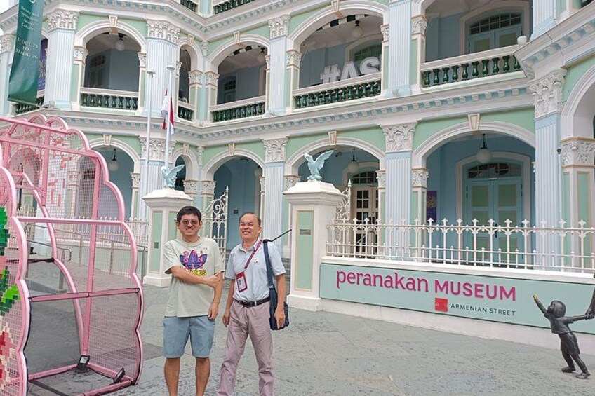 A building with a sign reading 'peranakan museum' and 'armenian street'. 5