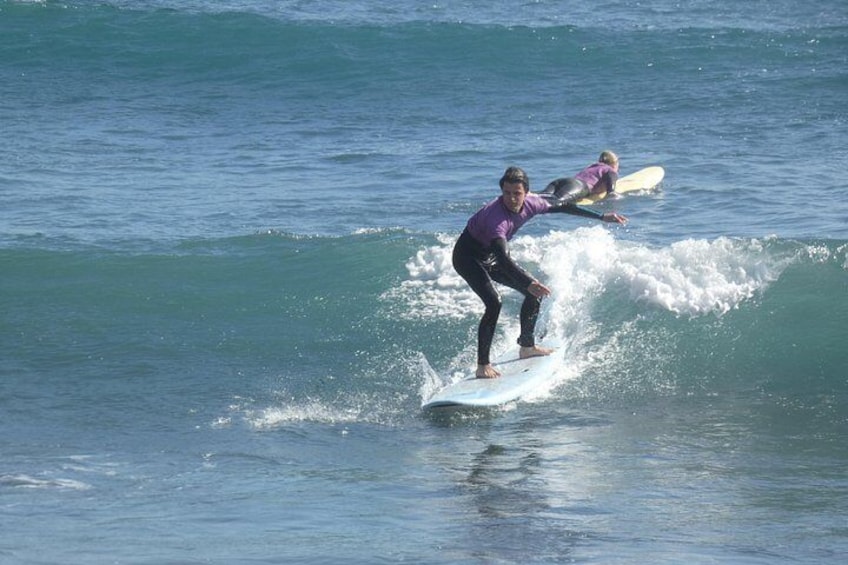 Beginner+ student riding a right hand green wave 2