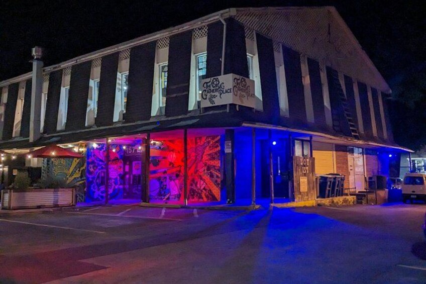 A building with a sign that reads 'The Garage Place' and a 'No Parking' sign. 3