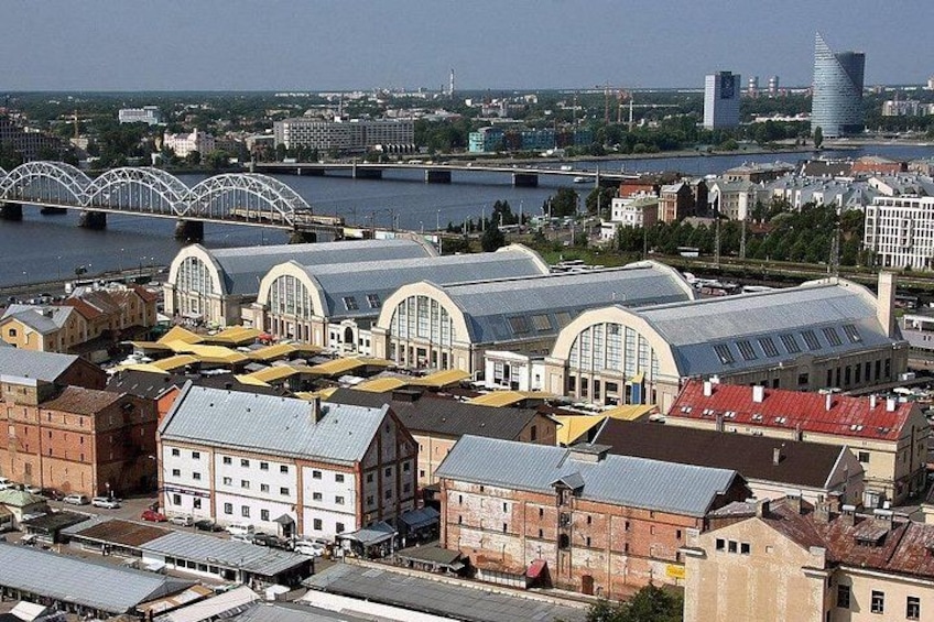 A cityscape with a river, bridges, and distinctive buildings with arched roofs. 2