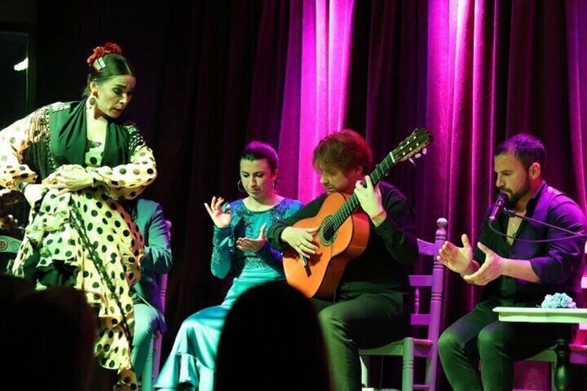 A stage performance with musicians and a dancer. 5