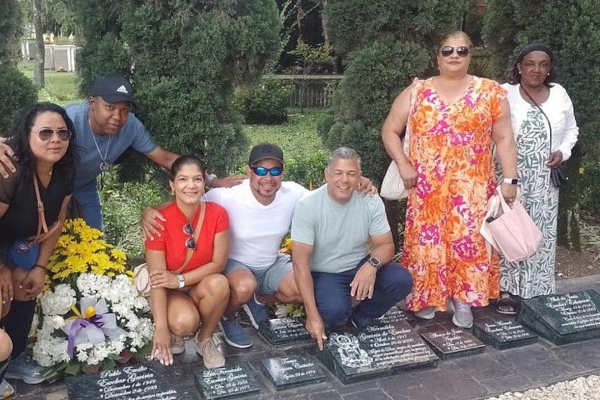 A group of people at a cemetery with headstones. 4
