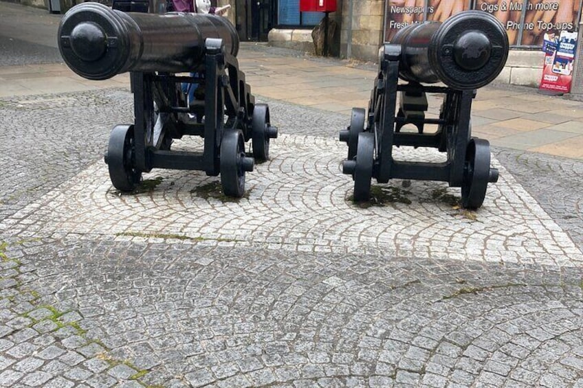 Dos cañones sobre un pavimento adoquinado. 2
