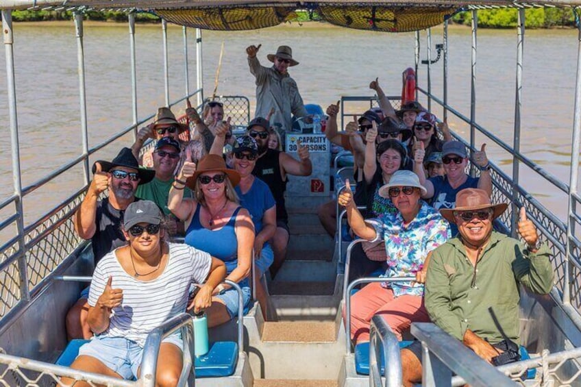A group of people on a boat with a sign that reads 'Capacity 30 Persons.' 1