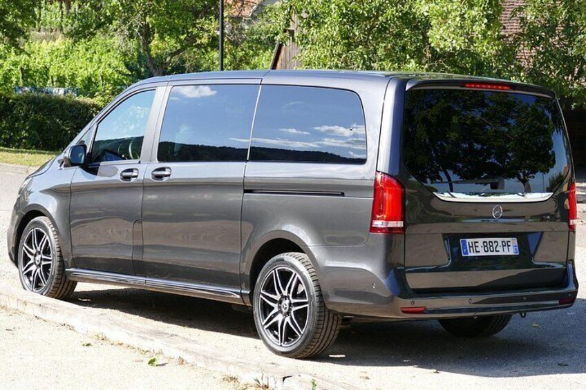 A silver van parked on a road with a license plate HE-882-PF. 3