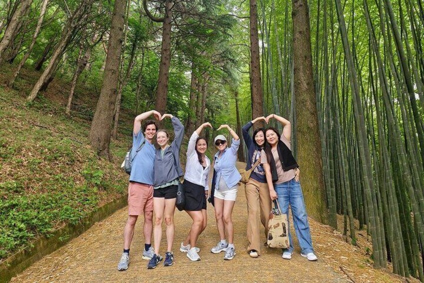 A group of people posing in a bamboo forest. 3