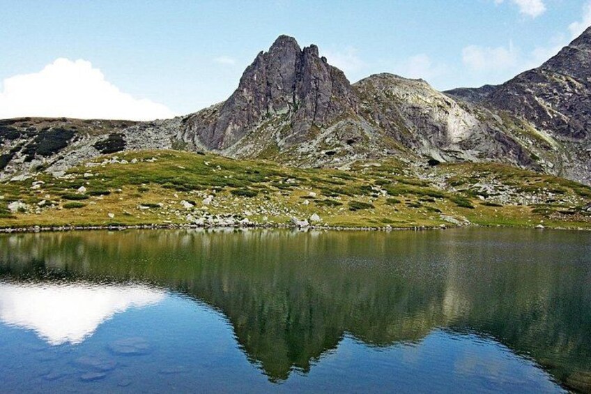 A mountain range, a lake, and a clear sky. 2