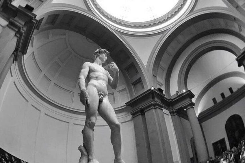 A classical statue in an architectural setting with arches and a dome. 4