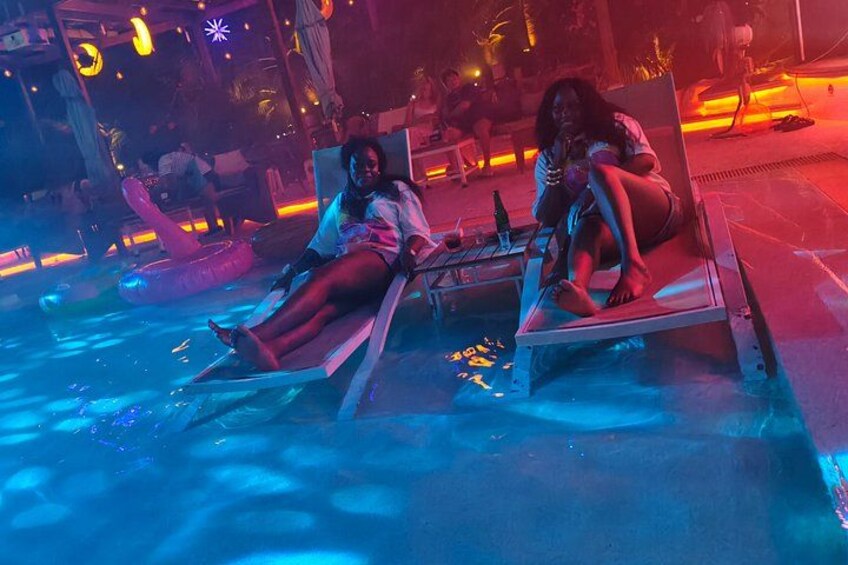 A poolside area with lounge chairs and inflatable floats. 3