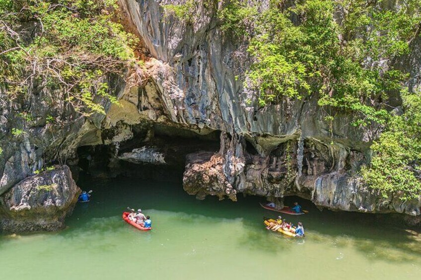 A cave entrance with kayaks in the water. 4