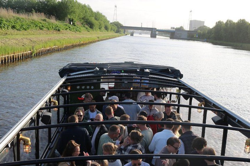 A boat filled with people traveling down a river. 2