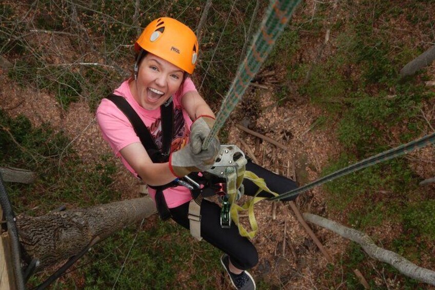 A person zip-lining through a forested area. 2