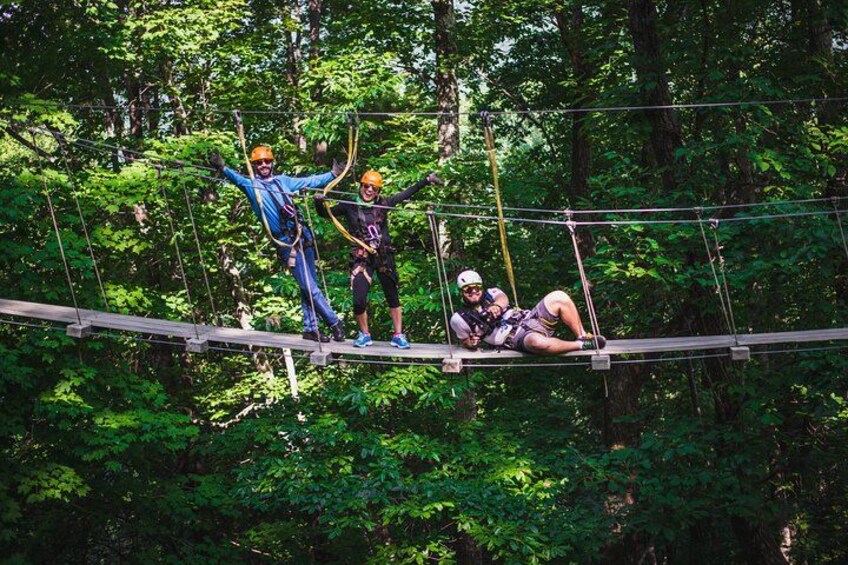 People on a suspended bridge in a forest. 3