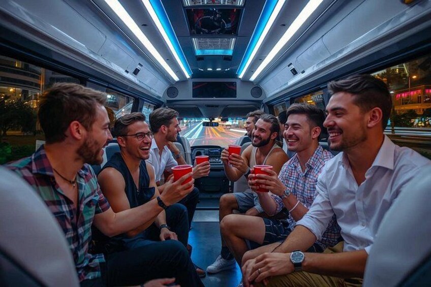 A group of people sitting inside a train, holding red cups. 4