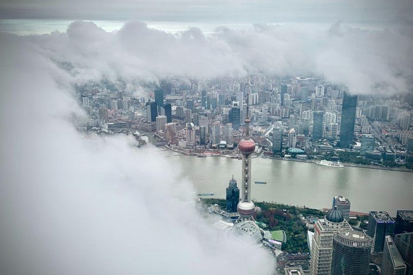 A cityscape with a prominent tower, a river, and surrounding buildings. 3