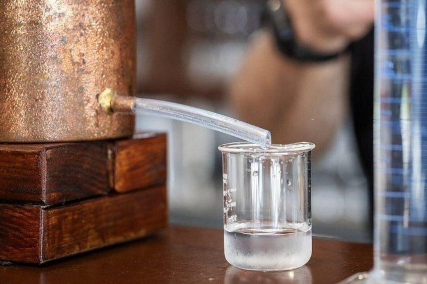 A copper water dispenser with a glass container. 3