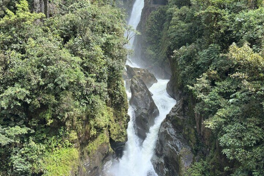 A waterfall cascading through a lush, green forest. 1