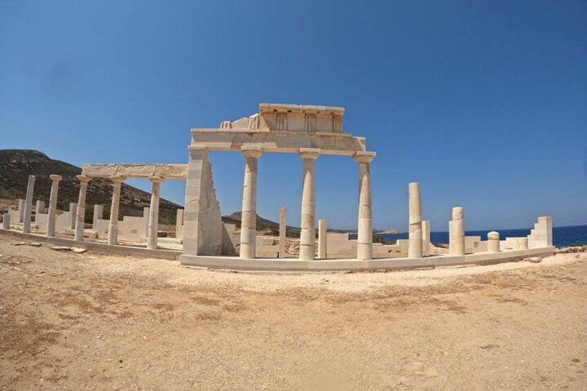 Ancient ruins with columns and a temple structure. 2