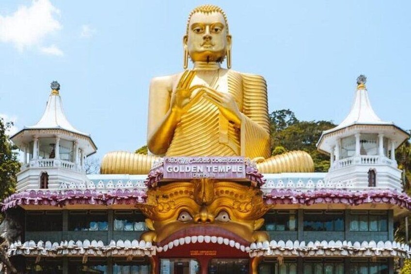 A large golden Buddha statue in front of a temple with two white towers and a sign that reads 'GOLDEN TEMPLE'. 4
