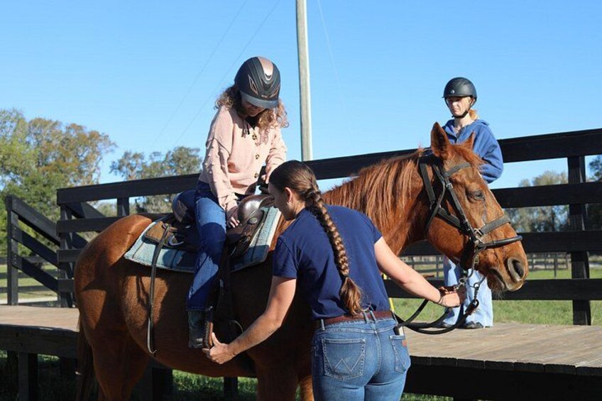 Riders are carefully helped onto their horses and given one-on-one instructions. 5