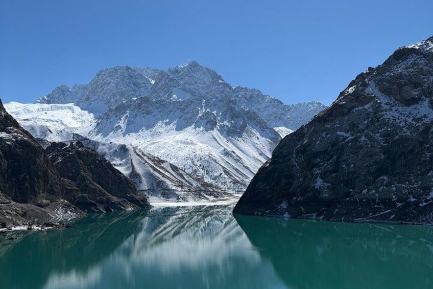 A glacier lake surrounded by snow-covered mountains. 4