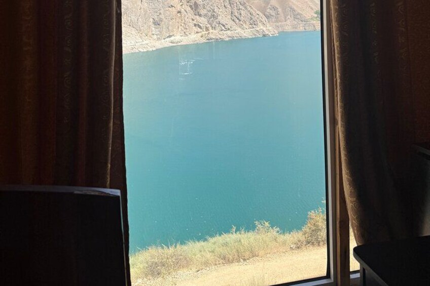 A view of a large body of water with a mountainous landscape in the background. 2