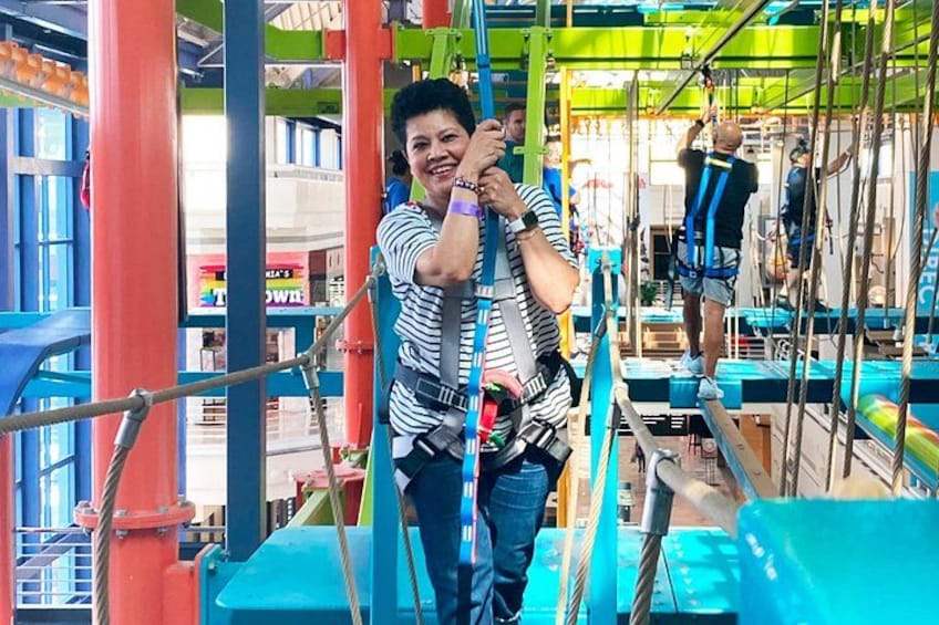 Adult woman enjoying the high ropes course 4