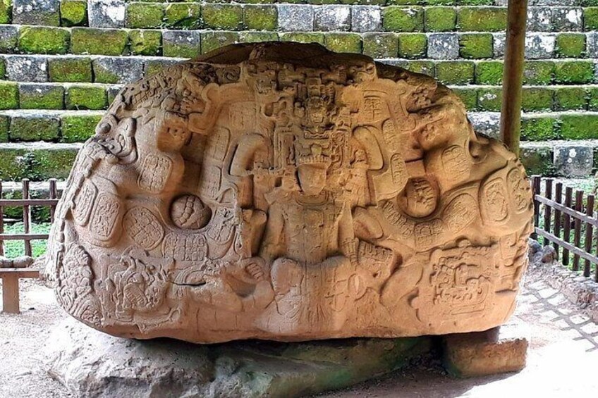 A large stone carving with intricate designs and figures. 1