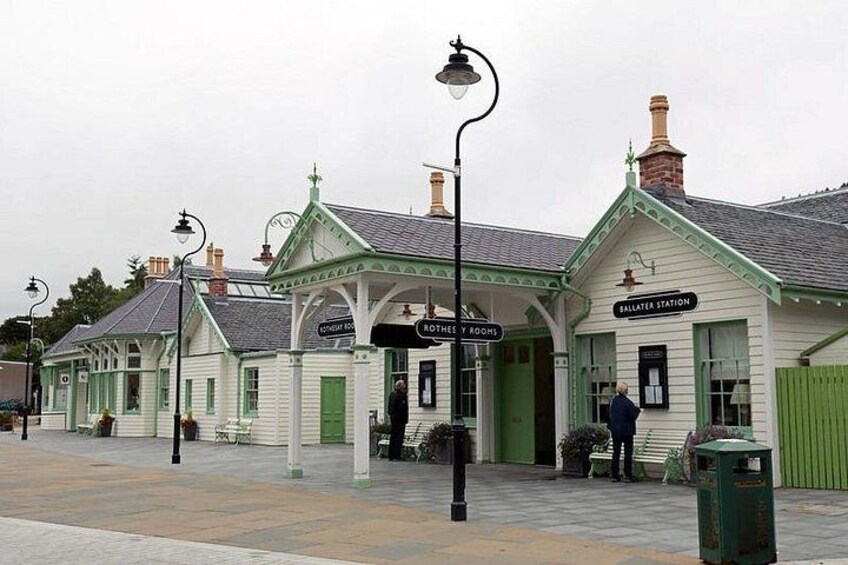 A traditional train station with green and white architecture, including a sign for 'SALISBURY STATION' and a 'BROTHER'S' sign. 5